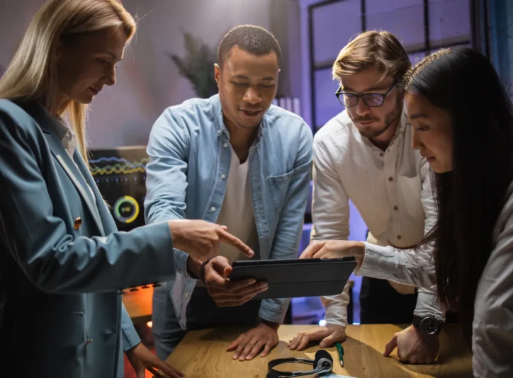 four-diverse-colleagues-having-conference-and-usin-2024-12-12-05-21-59-utc